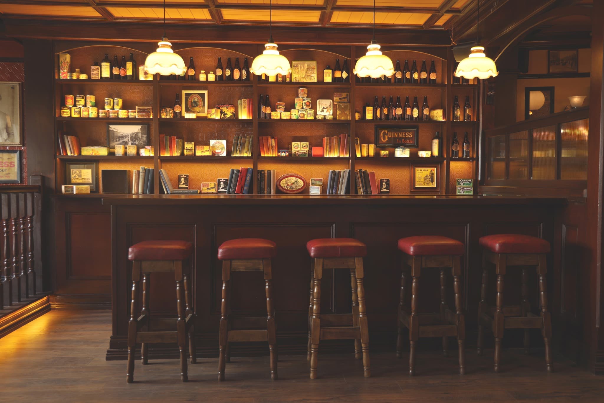 The back-bar heritage display — vintage tins, books and antique bottles